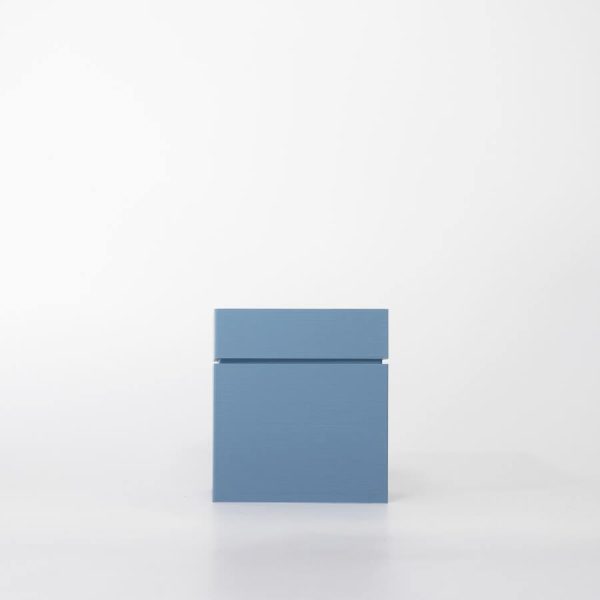 Buddy pet cremation urn. Image of modern cube urn in ocean.