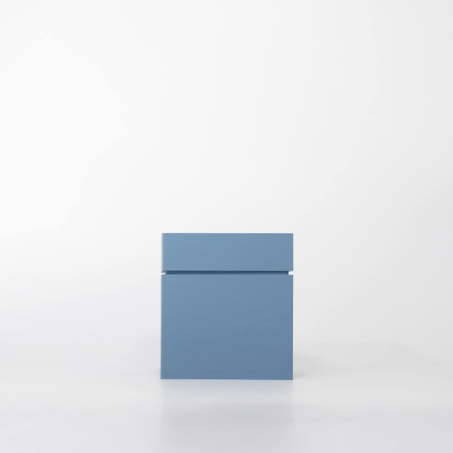 Buddy pet cremation urn. Image of modern cube urn in ocean.